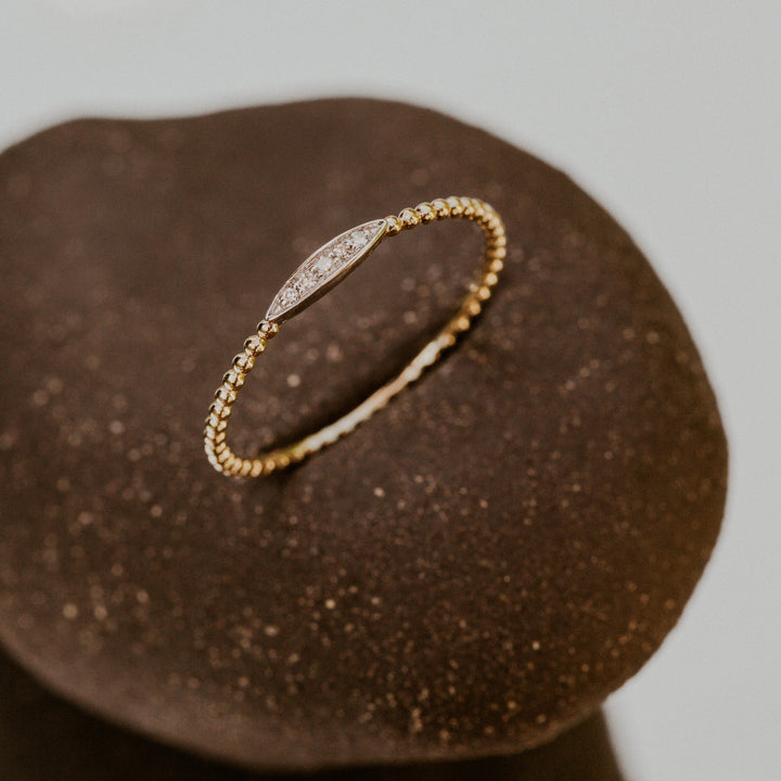 14k gold band with oval design filled with diamonds