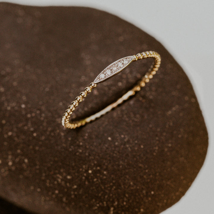 14k gold band with oval design on band filled with diamonds