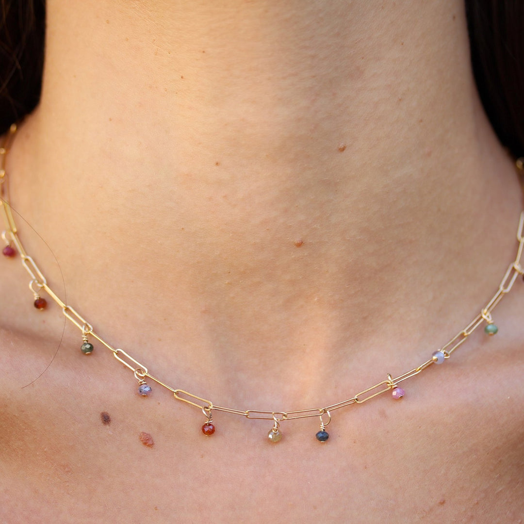 Close-up of the Juliette necklace at the base of the neck, small spinel beads spaced along a paperclip chain
