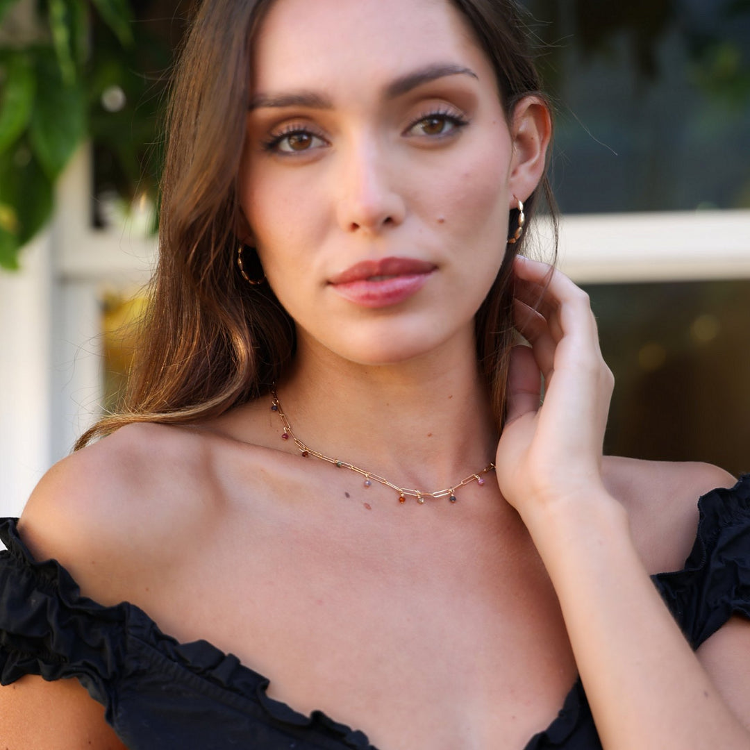 Model in a black off-the-shoulder top wearing the Juliette multicolored spinel necklace