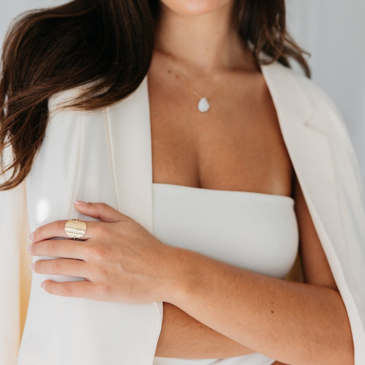 Katie Ring for women by Teressa Lane Jewelry worn on hand with white outfit and pendant necklace