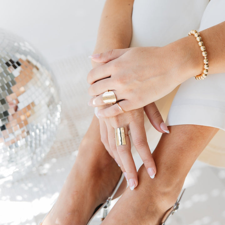 Katie Ring for women by Teressa Lane Jewelry worn on hand with gold bracelet and stylish silver heels