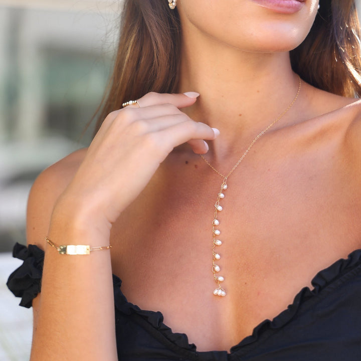 Model wearing the Kim gold filled bar bracelet with the Celeste pearl Y-drop necklace