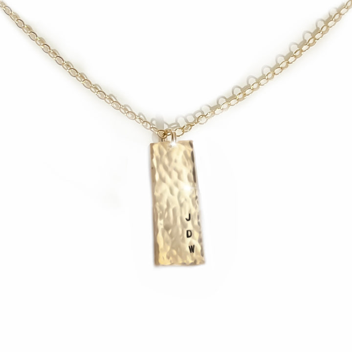 Personalized gold necklace by Teressa Lane Jewelry with hammered rectangular pendant and initials