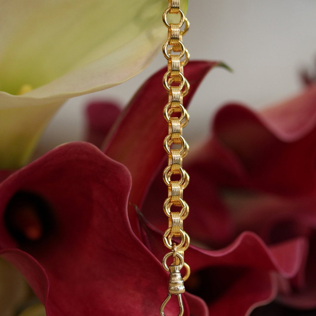 Vivienne gold filled chain bracelet hanging from a calla lily, finished with a swivel clasp