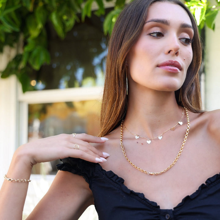 Vivienne gold filled chain and Heart necklace layered together, worn with a black off-the-shoulder top