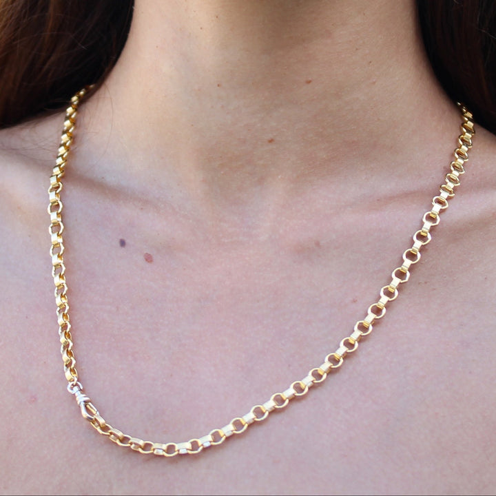 Model wearing the Vivienne necklace, a substantial 14k gold filled chain of round and ribbed links, with the swivel clasp at the front