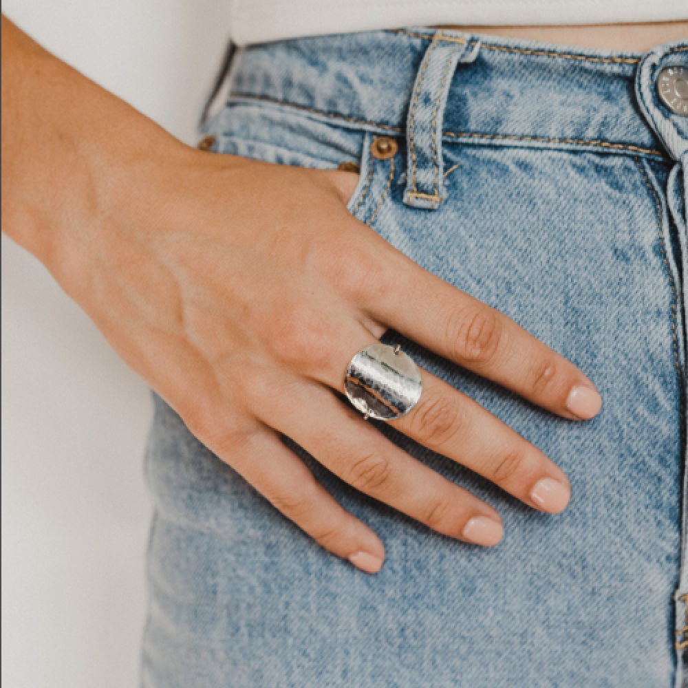 Katie Ring for women by Teressa Lane Jewelry worn on hand with silver hammered texture and casual denim jeans