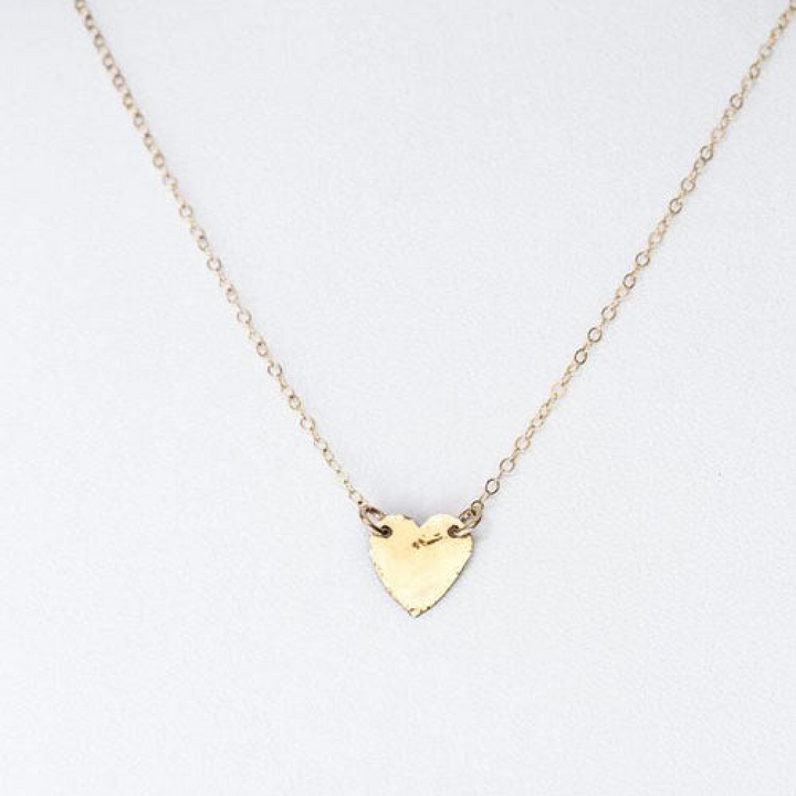 Teressa Lane Jewelry delicate gold heart necklace with a small textured pendant on thin chain